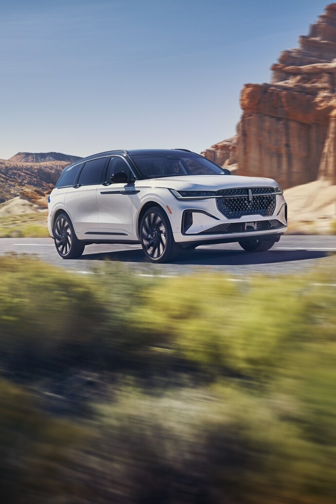 The 2024 Lincoln Nautilus driving down a road in the desert.