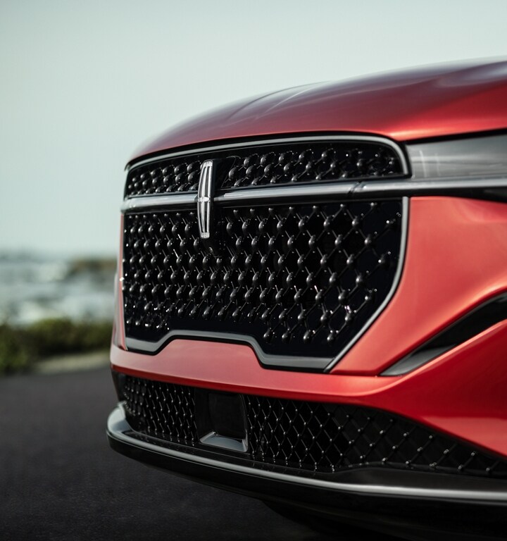 The grille of a 2024 Lincoln Nautilus® SUV with the available Jet Appearance Package sparkles in the sunlight