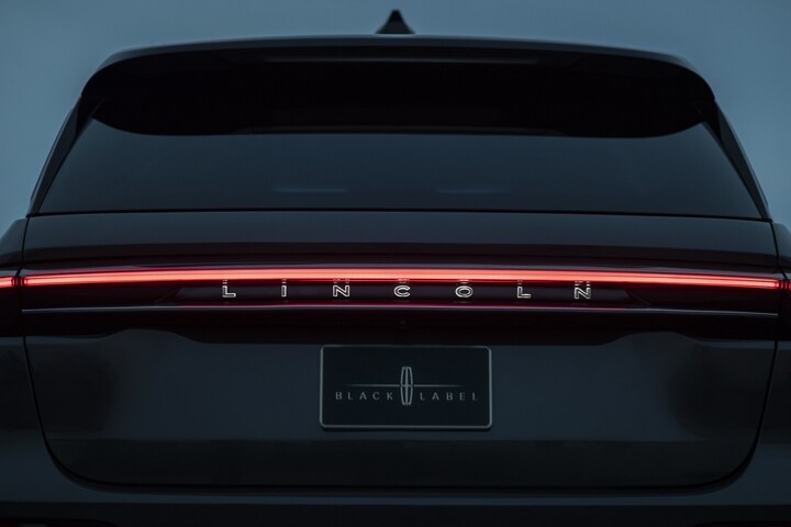 The rear light bar of a 2025 Lincoln Black Label Nautilus® SUV is illuminated at night