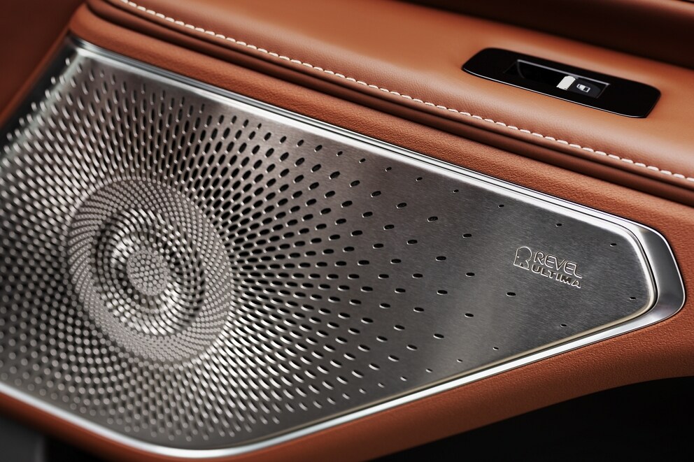 A front speaker with a metallic cover of the 28-speaker Revel Audio System is shown