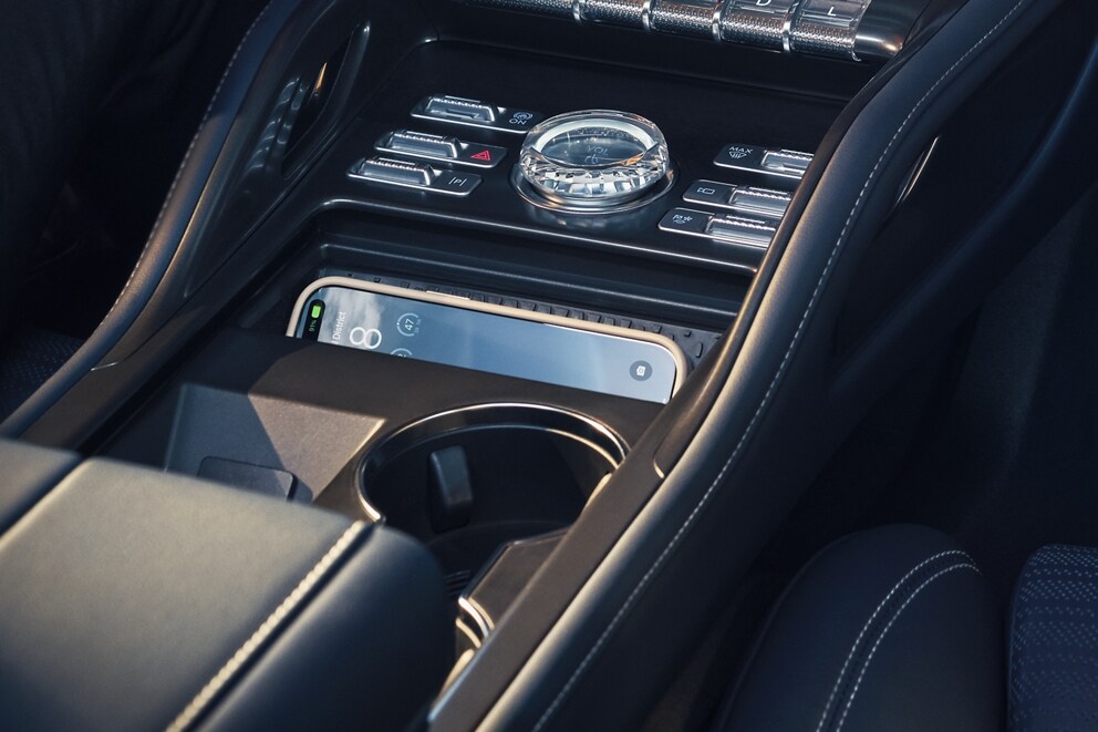 A smartphone is charging on the wireless charging pad