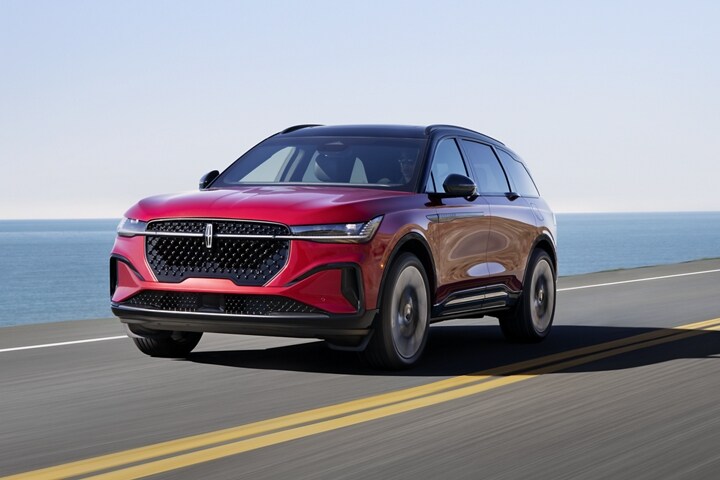 A 2025 Lincoln Nautilus® SUV is being driven on a seaside roadway