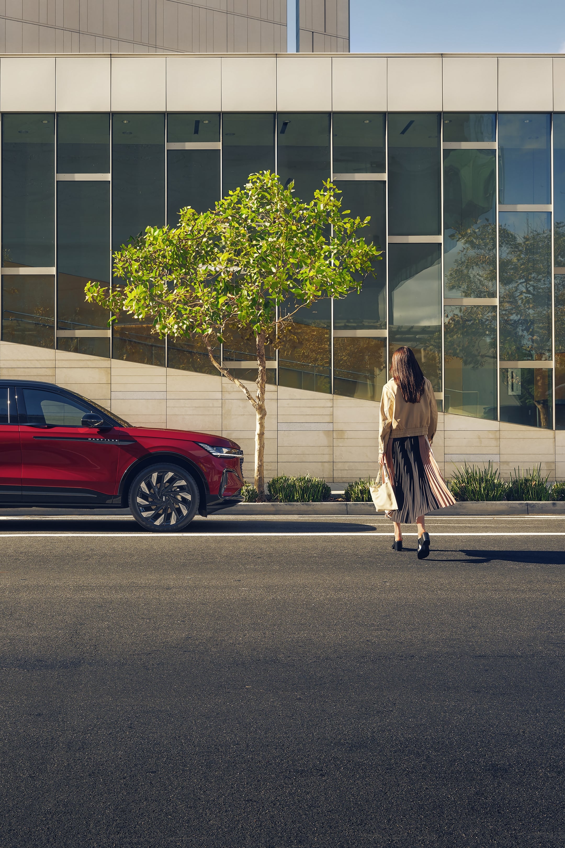 A woman is seen walking toward a 2025 Lincoln Nautilus