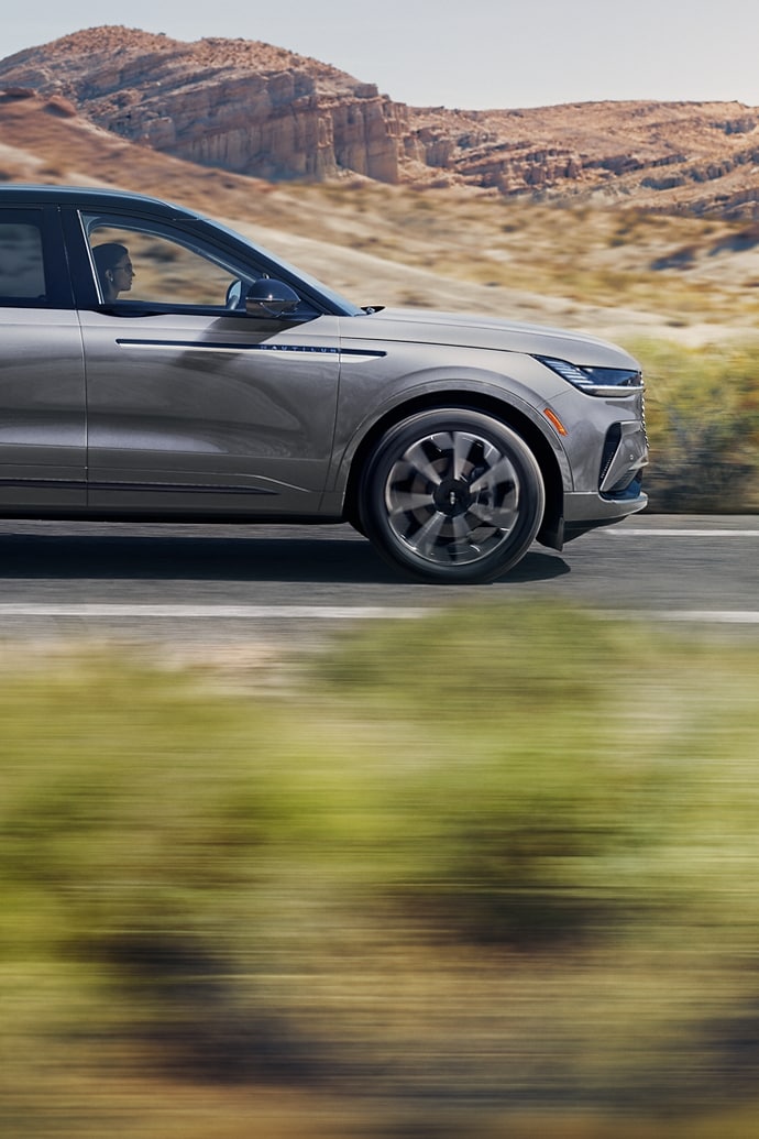 The 2025 Lincoln Nautilus is seen driving on a road