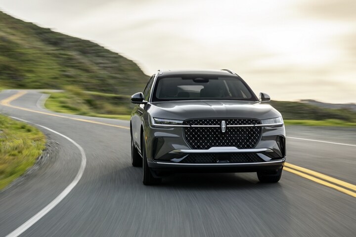 A 2026 Lincoln Black Label™ Nautilus® SUV is being driven on a waterfront roadway