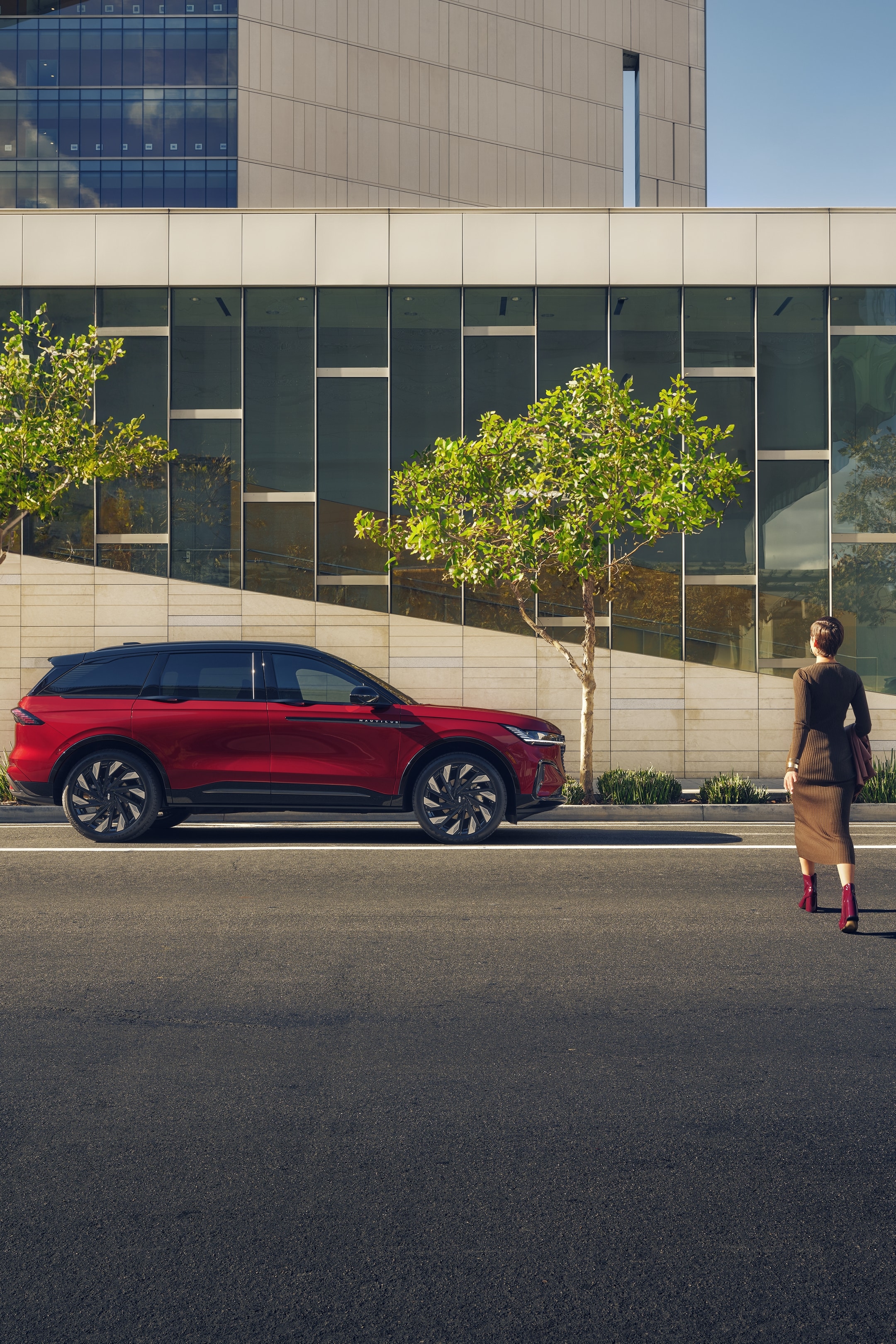 A woman is seen walking toward a 2026 Lincoln Nautilus® SUV