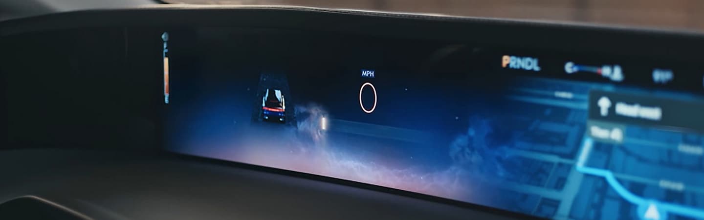 The driver of a 2026 Lincoln Nautilus® SUV touches the center touch screen to alter the display theme of the panoramic display