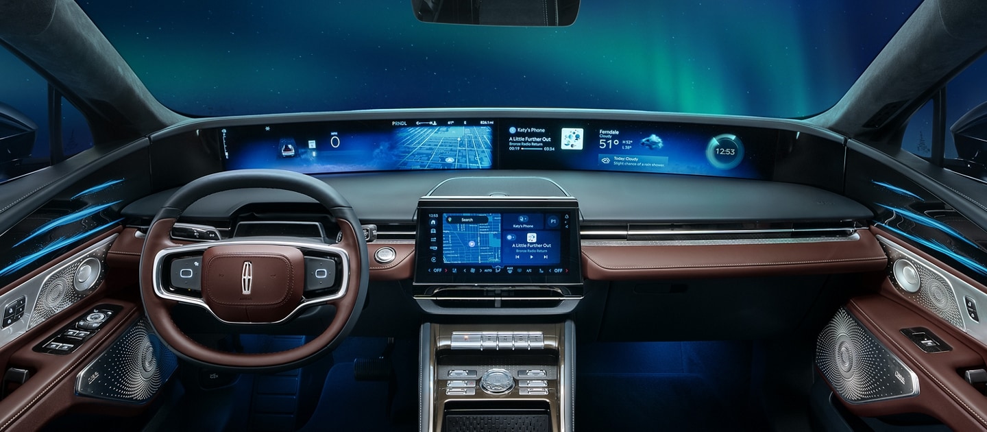 The northern lights light up the night sky as seen through the windshield of a 2026 Lincoln Black Label™ Nautilus® SUV with the Aurora interior theme
