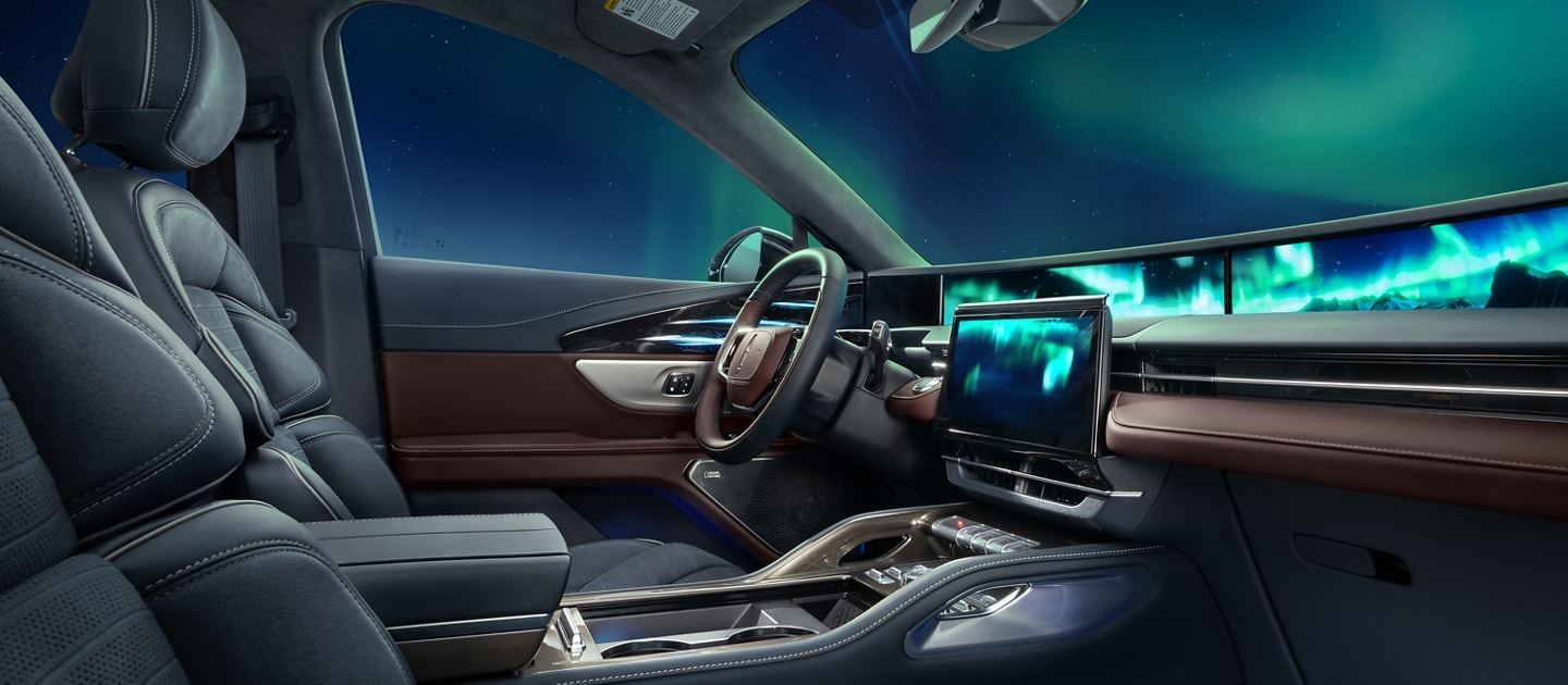 The northern light lights up the night sky as seen through the windshield of a 2026 Lincoln Black Label™ Nautilus® SUV with the Aurora interior theme