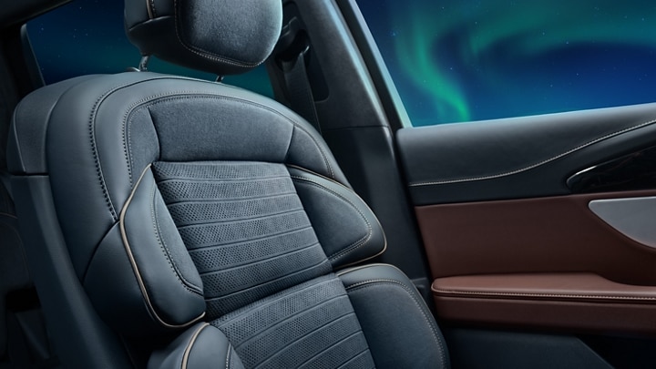 The driver's seat of a 2026 Lincoln Black Label™ Nautilus® SUV with  Allura Blue Dinamica leather seating surfaces of the new Aurora interior theme