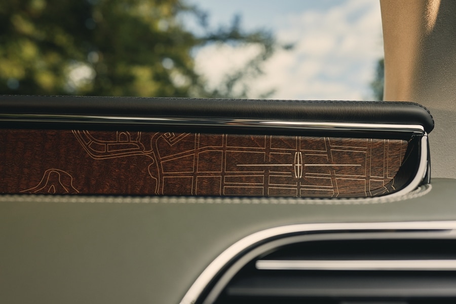 A detail shot of the Central Park trails laser etched into the genuine wood inlay of the front dashboard.