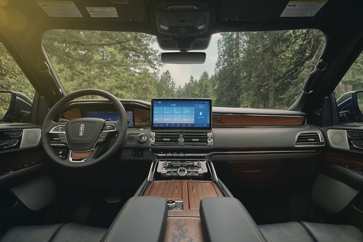 El interior de una SUV Lincoln Black Label Navigator® 2023 en el tema Invitation muestra la cabina lujosa.