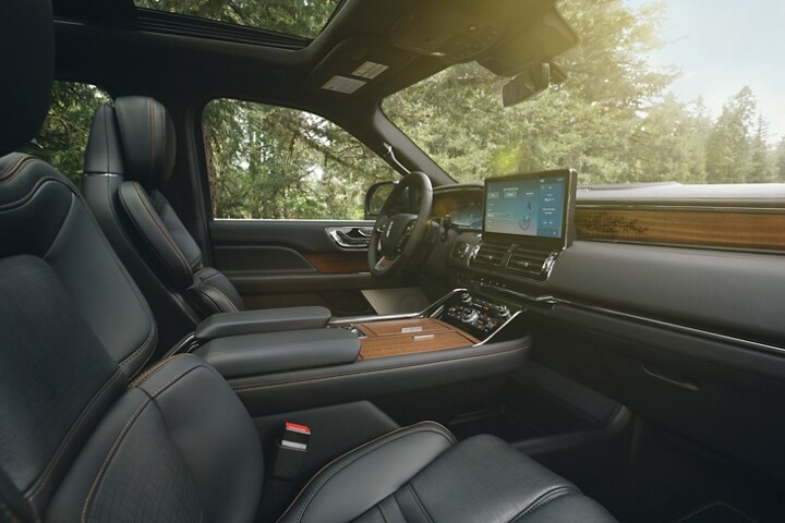 The front seats of a 2023 Lincoln Black Label Navigator® SUV in Invitation theme show off leather seating surfaces.