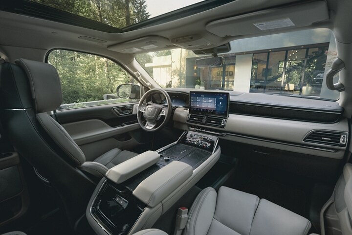 The front cabin of a 2023 Lincoln Navigator® SUV shows off comfortable premium leather seating surfaces.