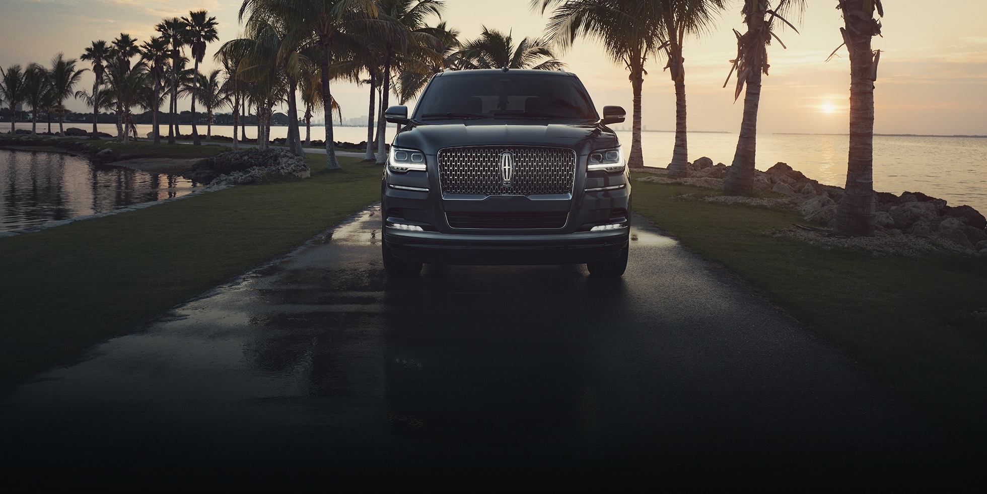 The 2023 Lincoln Navigator parked on a road in front of the ocean.