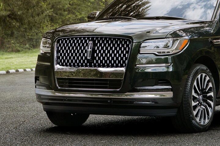 A low front-end shot of a 2023 Lincoln Black Label Navigator® SUV emphasizes the distinguished chrome grille design.