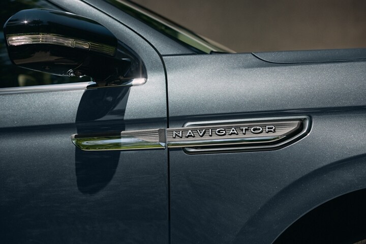 The nameplate badge on 2023 Lincoln Navigator® SUV in Flight Blue shows off geometric design.