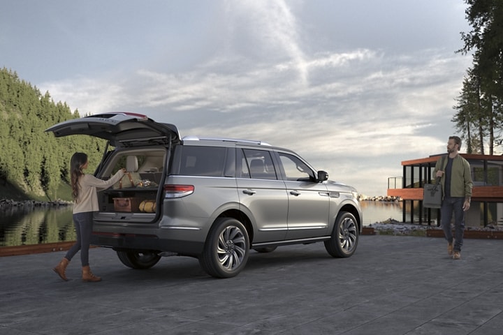 The cargo area of a 2023 Lincoln Black Label Navigator® SUV vehicle shows high-end gear and comforts for a nature adventure.