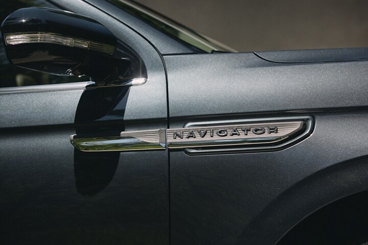 The nameplate badge on 2024 Lincoln Navigator® SUV in Flight Blue shows off a geometric design.