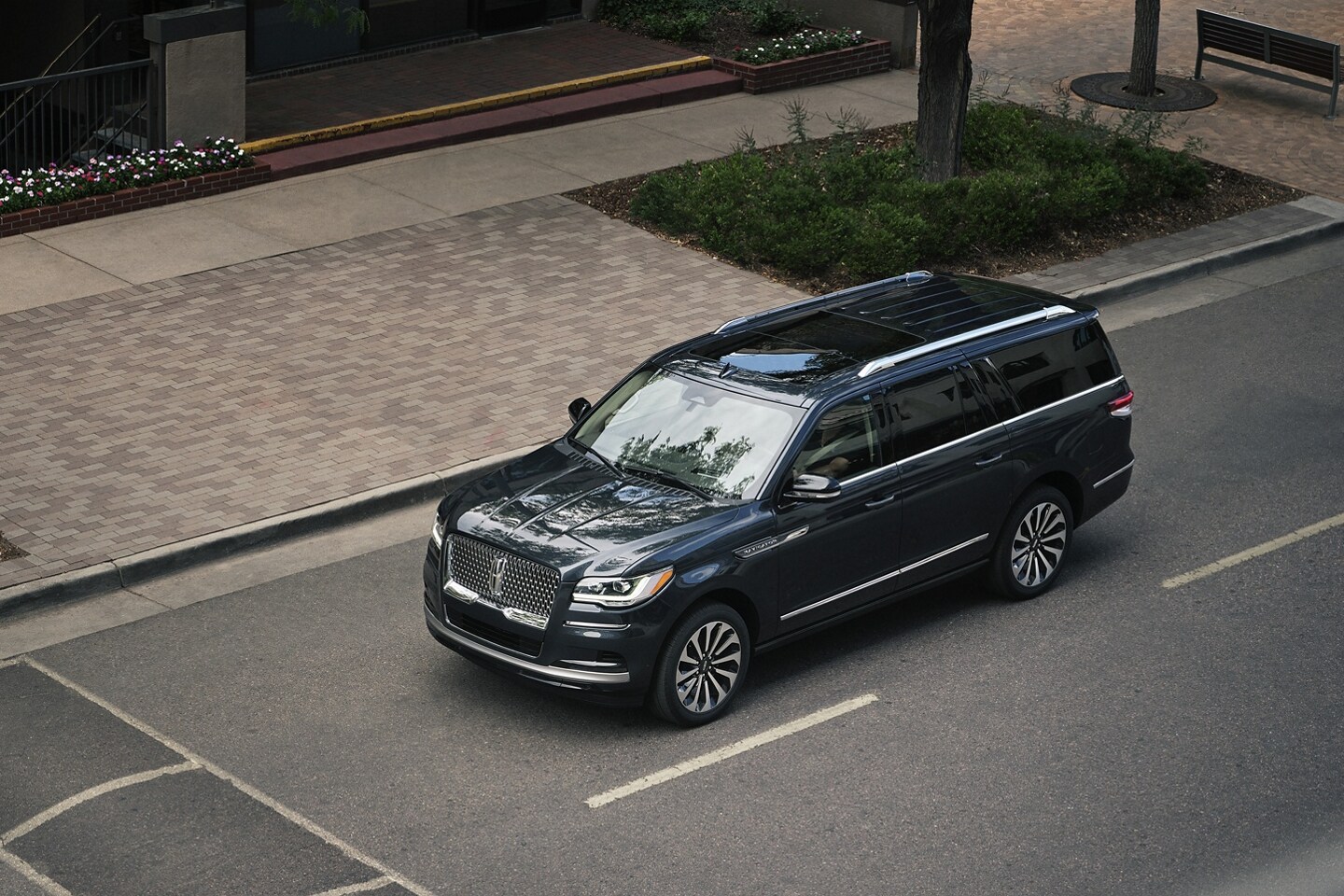A 2024 Lincoln Navigator® SUV is being driven toward a speed bump on a downtown street.