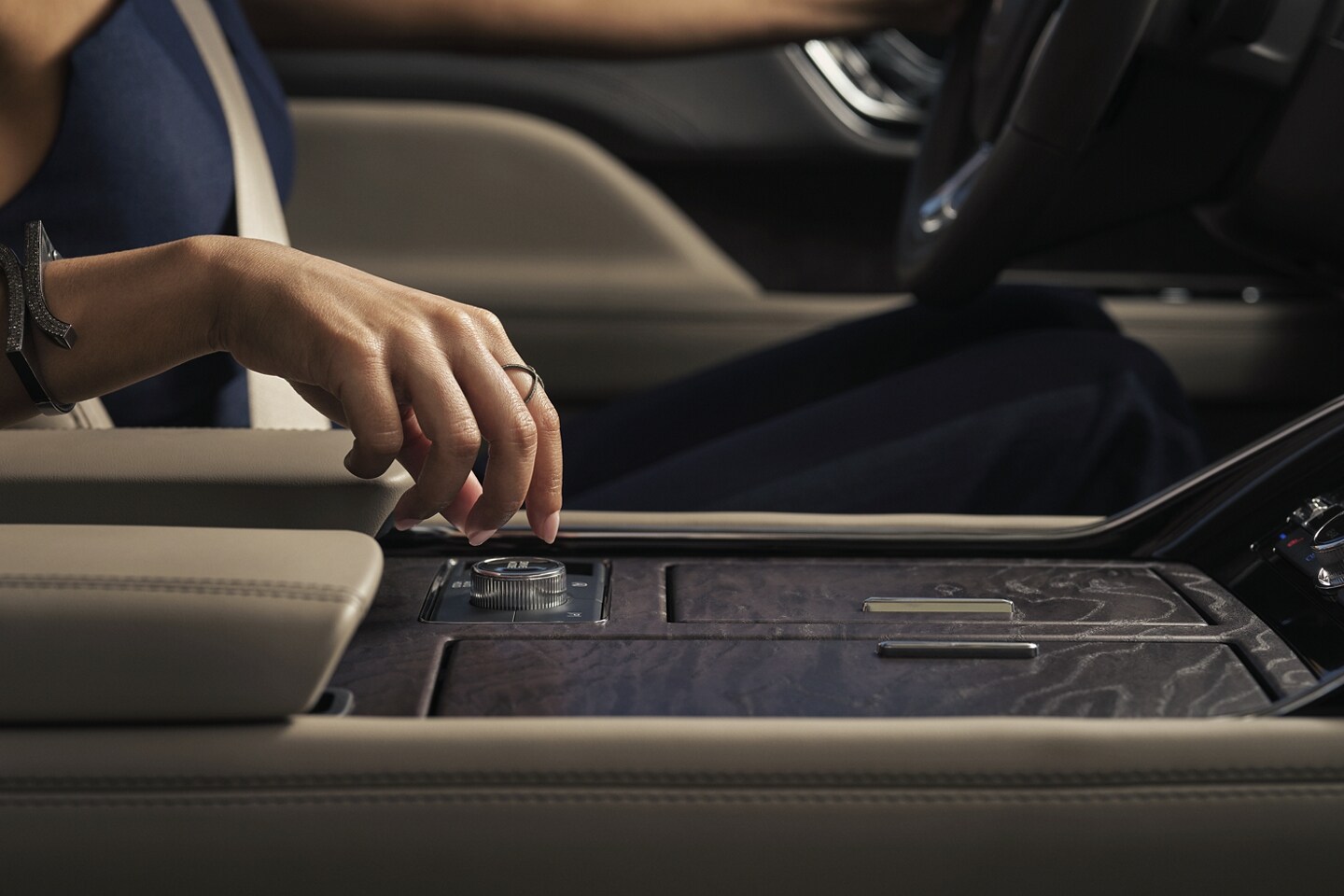 A hand is turning the Lincoln Drive Modes knob inside a 2024 Lincoln Navigator® SUV.
