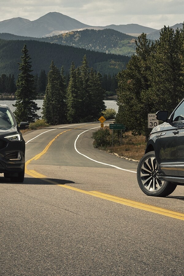 A 2024 Lincoln Navigator® SUV is making a left turn as another vehicle approaches from the other lane