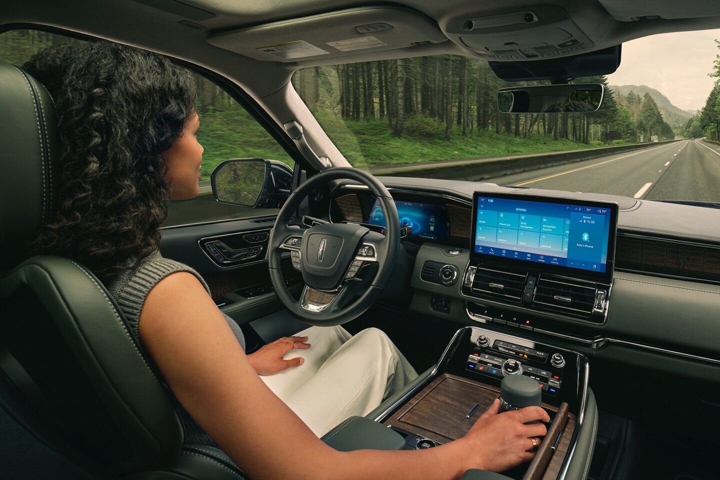 A driver of a 2024 Lincoln Black Label Navigator® SUV relaxes with hands-free driving technology engaged.