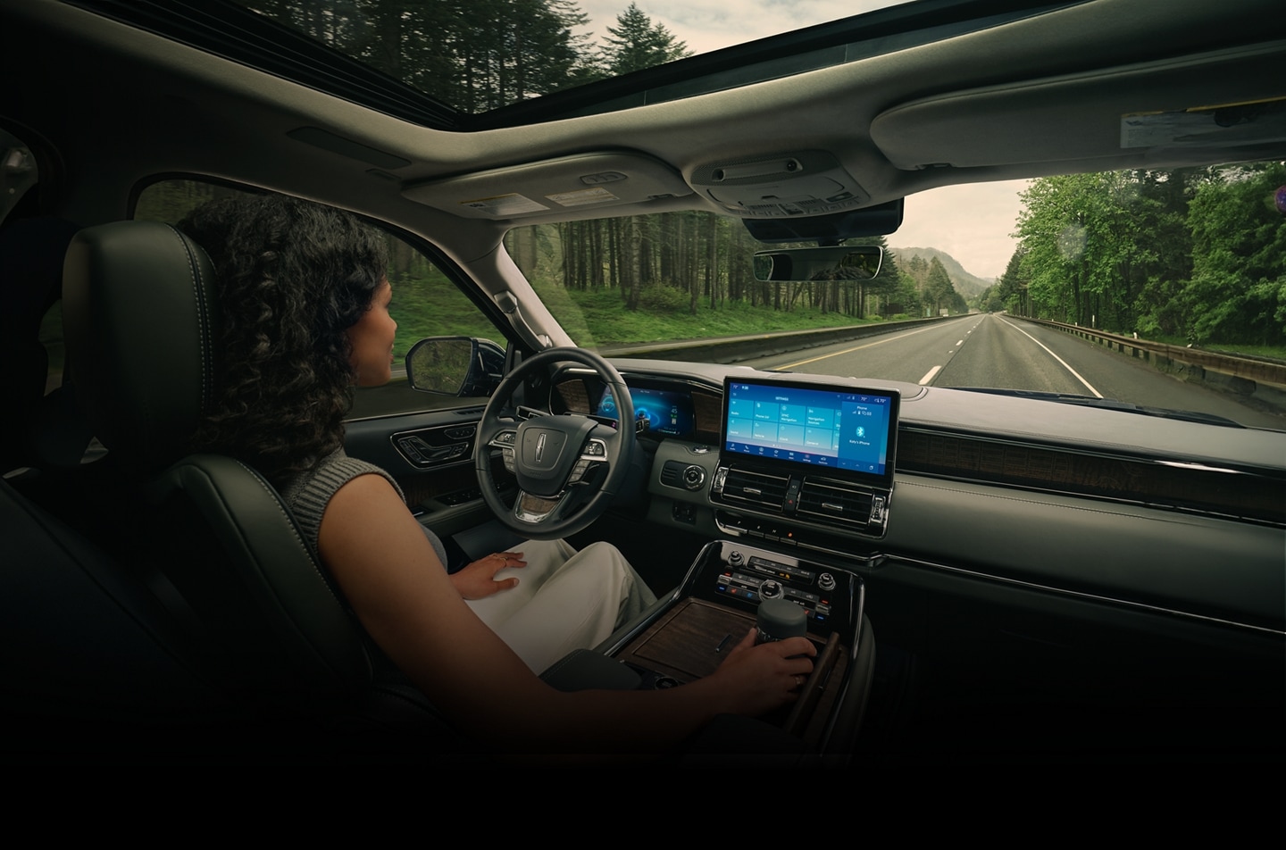 A driver of a 2024 Lincoln Black Label Navigator® SUV relaxes with hands-free driving technology engaged
