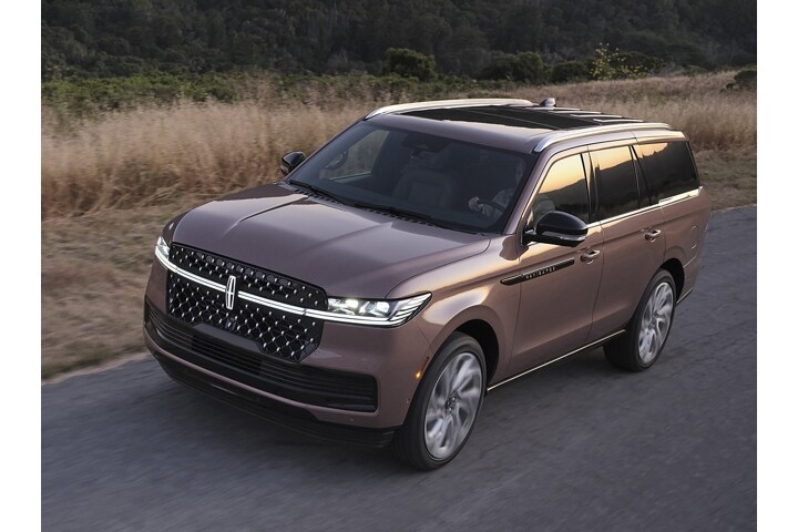 2025 Lincoln Black Label Navigator® SUV is being driven on a rural road