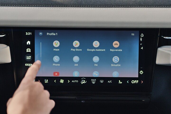 A finger presses the personal profiles tab on the center touchscreen of a 2025 Lincoln Black Label Navigator® SUV
