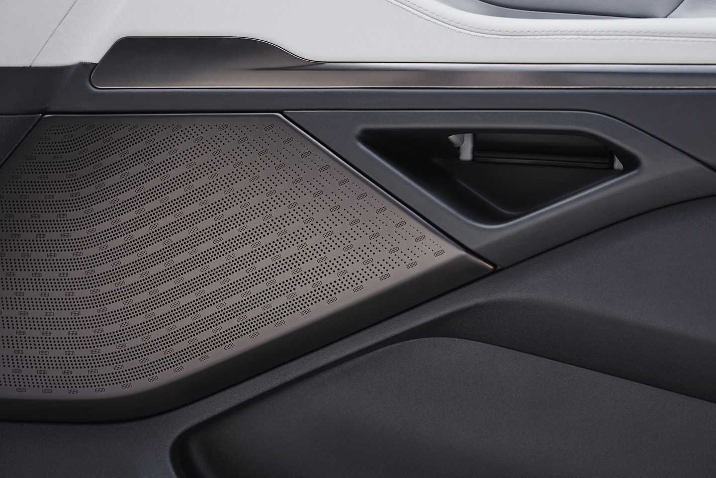 A Revel® Ultima 3D Audio System speaker positioned in the front passenger door