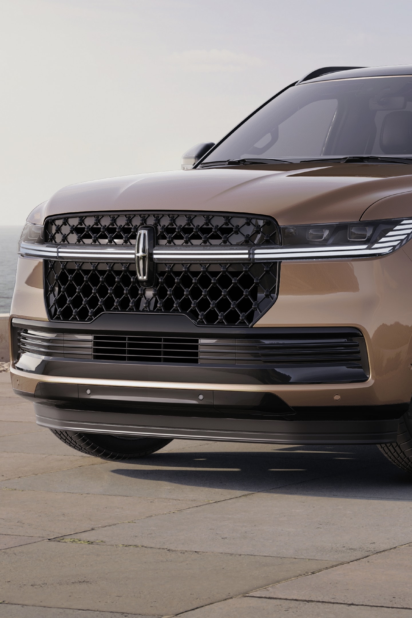 A 2025 Lincoln Navigator® SUV is parked at a scenic ocean-side overlook.