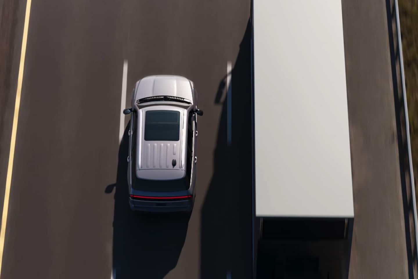 A 2025 Lincoln Navigator® SUV uses In-Lane Repositioning for more room away from a semi truck in the adjacent lane